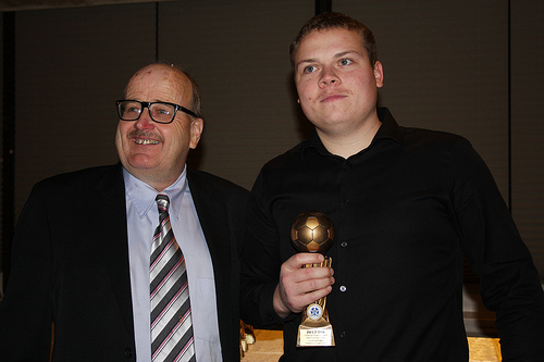 Dan Burns, right, accepts MVP trophy for Josh Elgeti