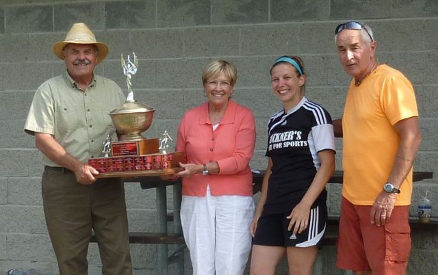 Fred and Margaret Forster present the Ladies Trophy to Welland Buckner’s Sport team captain and team coach